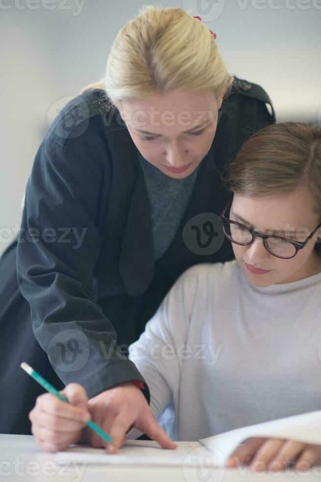 professora ajudando os alunos na aula foto