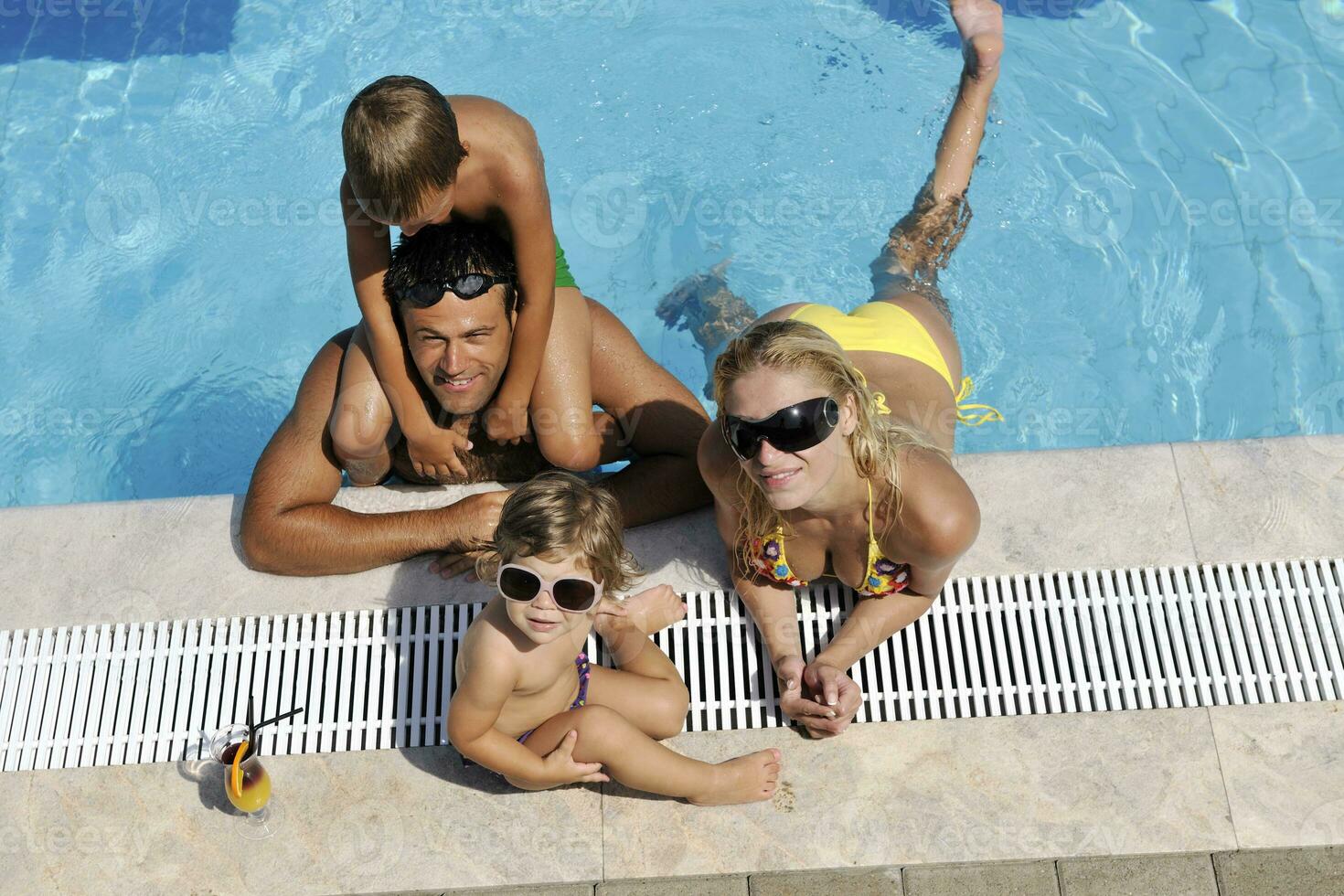 feliz jovem família se divertir na piscina foto