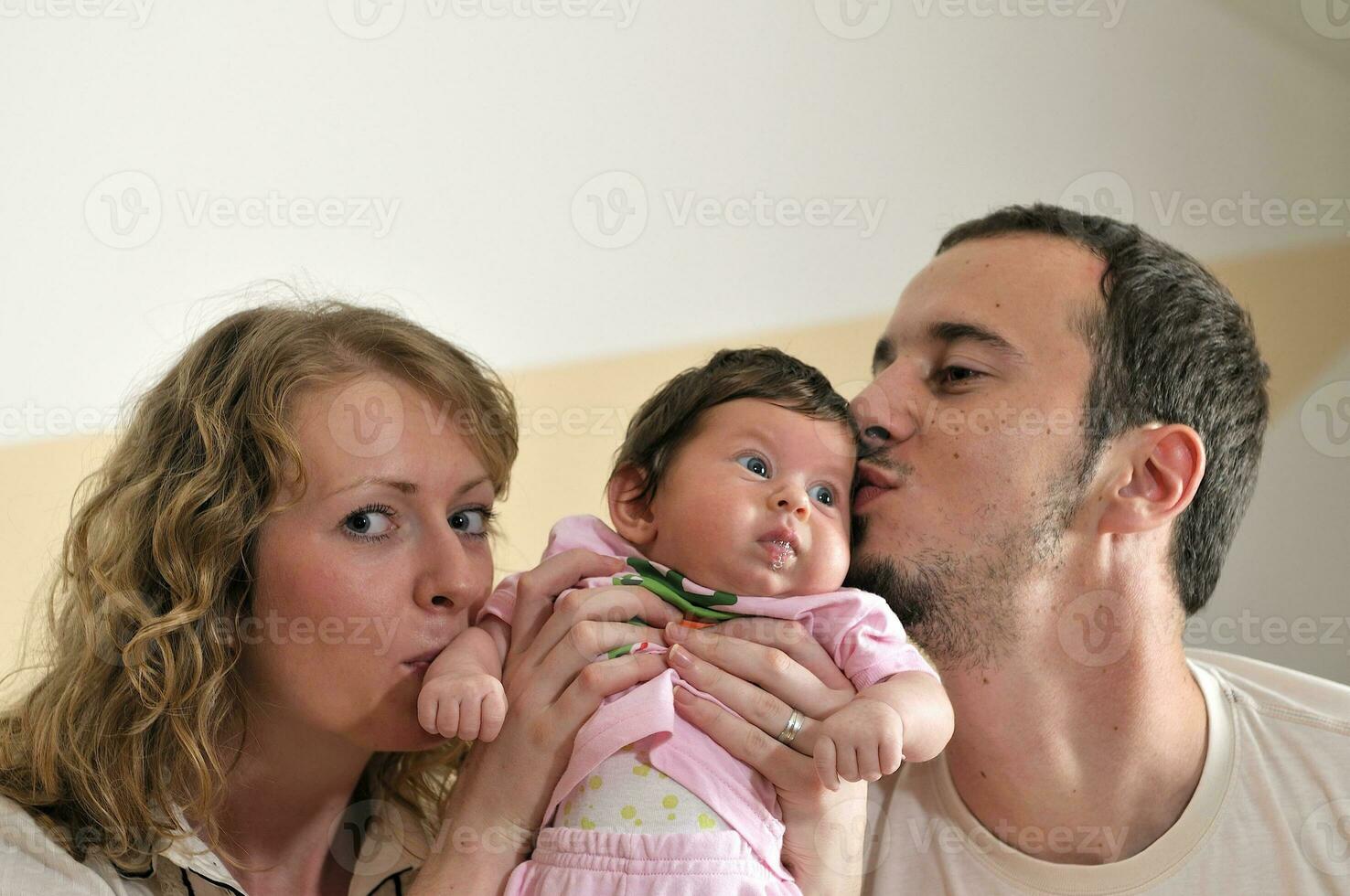 retrato interior com família jovem feliz e bebezinho fofo foto