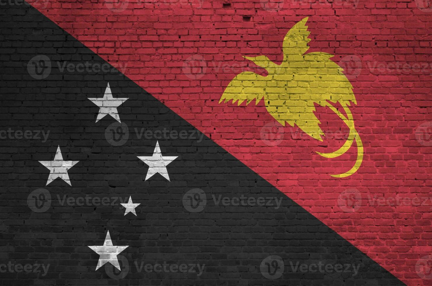 papua Novo Guiné bandeira retratado dentro pintura cores em velho tijolo muro. texturizado bandeira em grande tijolo parede alvenaria fundo foto