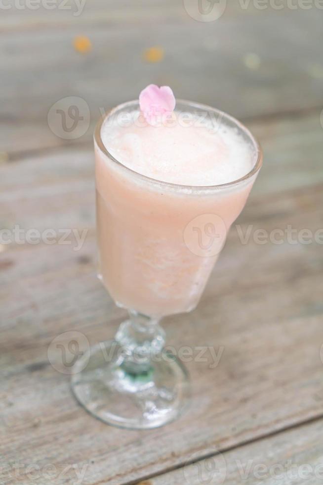 lichia com suco de rosa na mesa de madeira foto