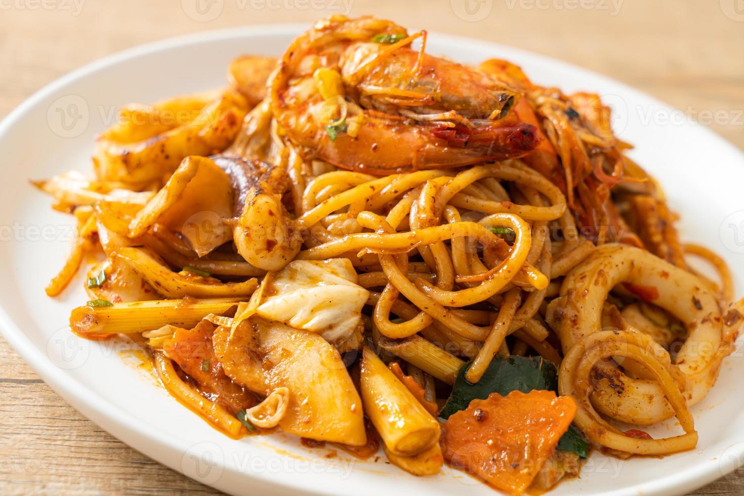 espaguete seco com frutos do mar frito tom yum - estilo de comida de fusão foto