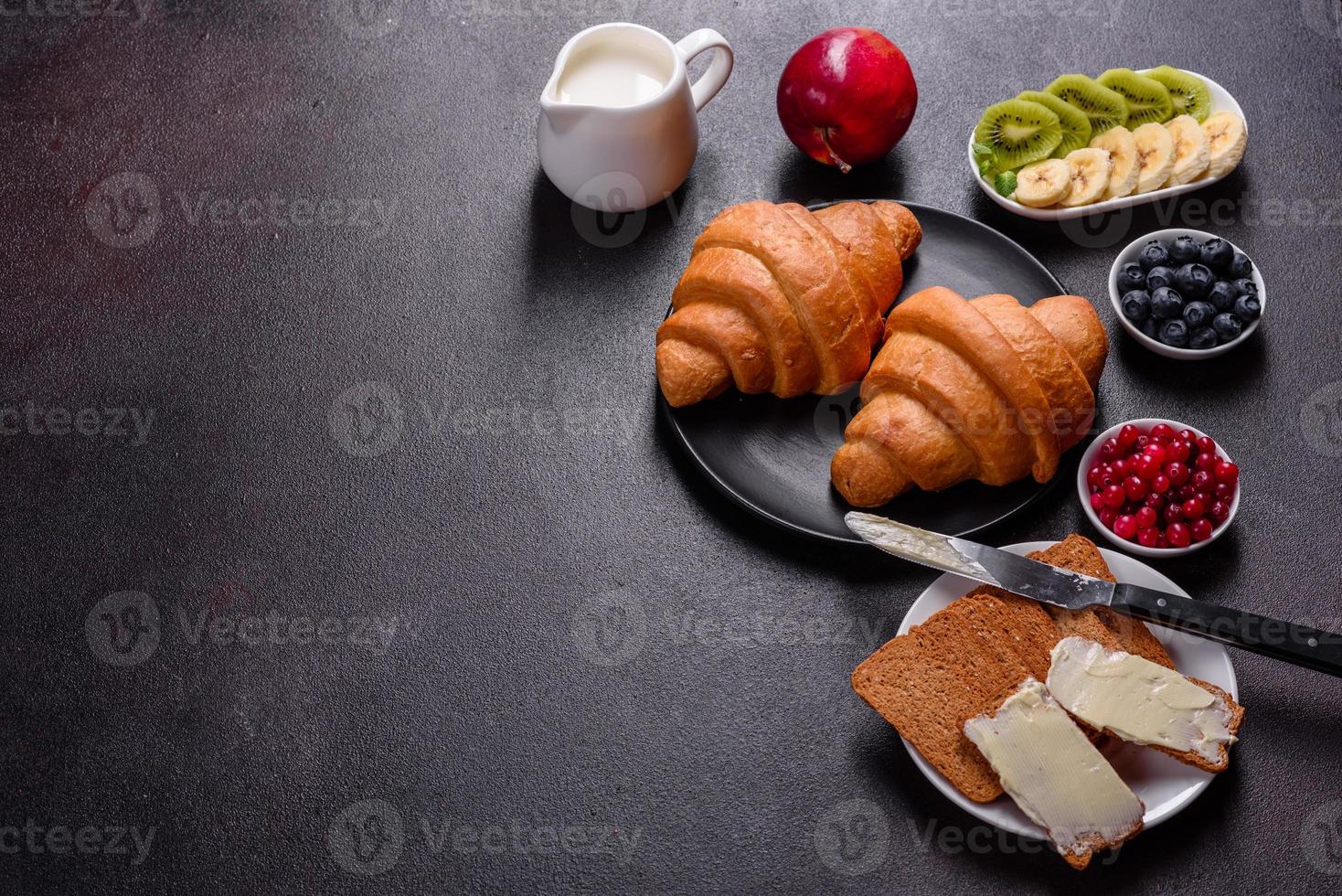 delicioso café da manhã com croissants frescos e frutas vermelhas maduras foto