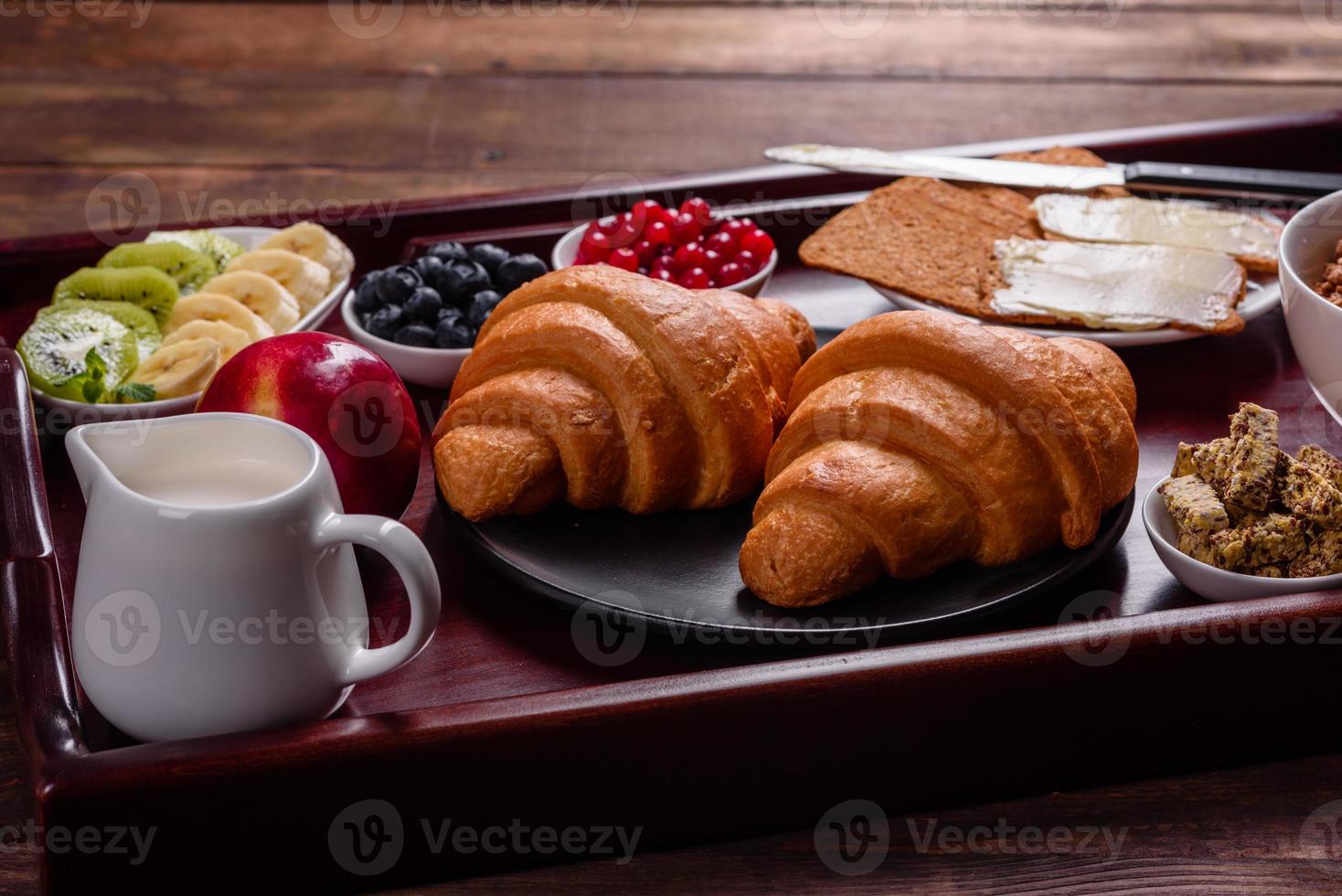 delicioso café da manhã com croissants frescos e frutas vermelhas maduras foto