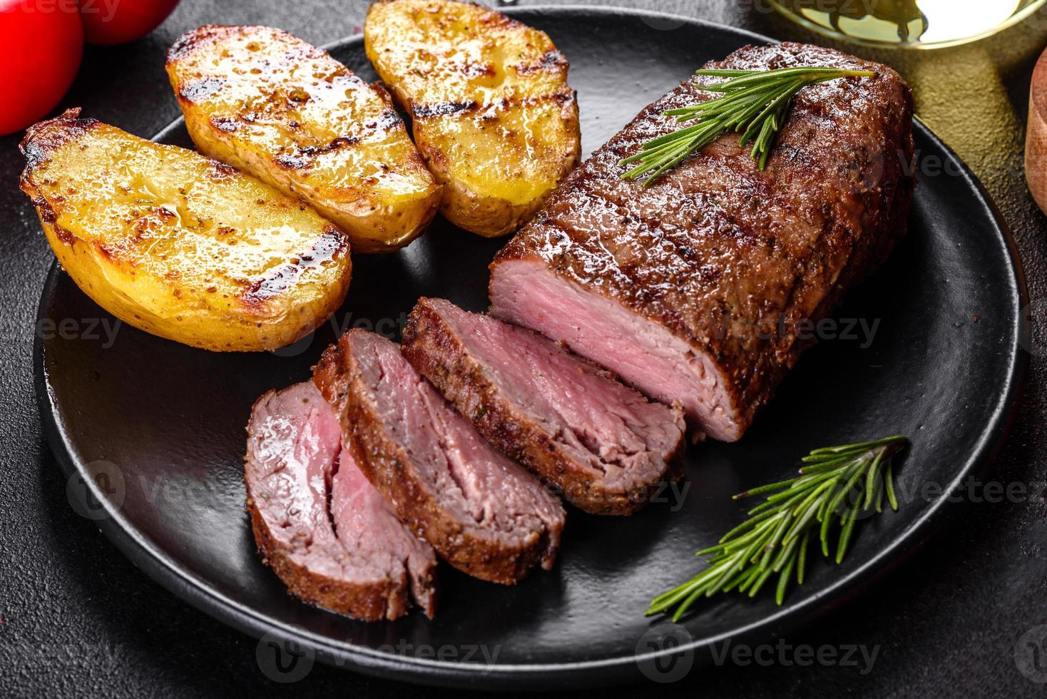 bife de lombo com batata, cebola e tomate cereja foto