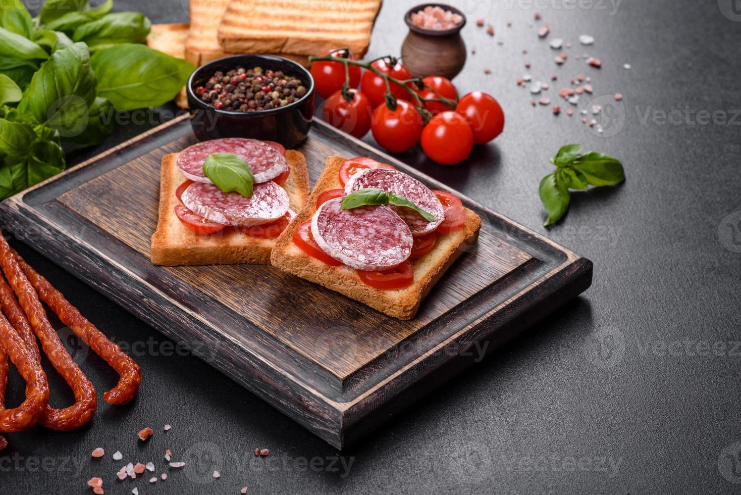 Salame de linguiça seca espanhola em um fundo escuro de concreto foto