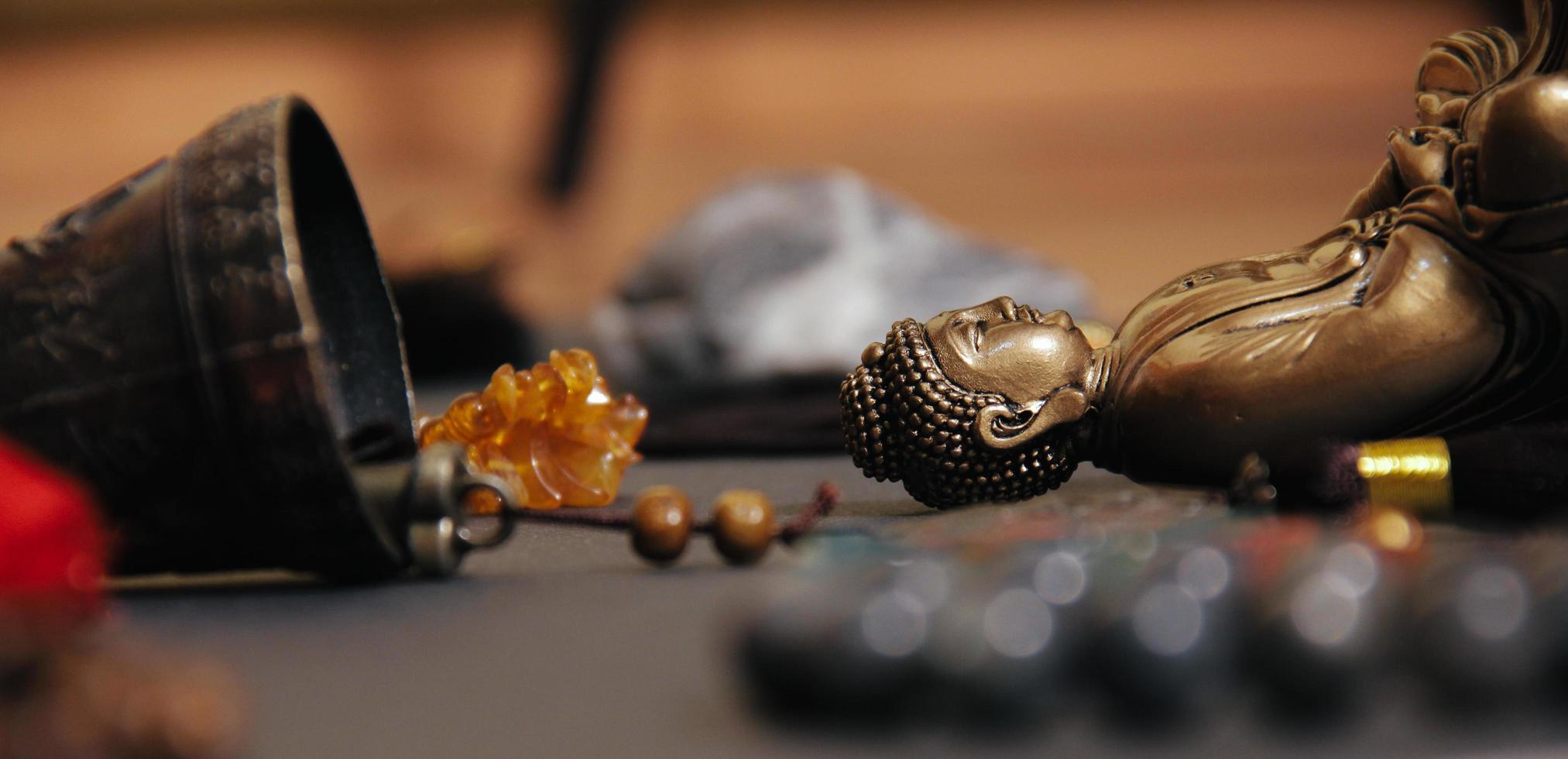 close-up do altar oculto com a estatueta de Buda, rosários de pedra foto