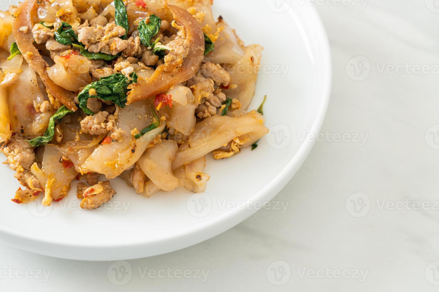 macarrão frito com frango picado e manjericão foto