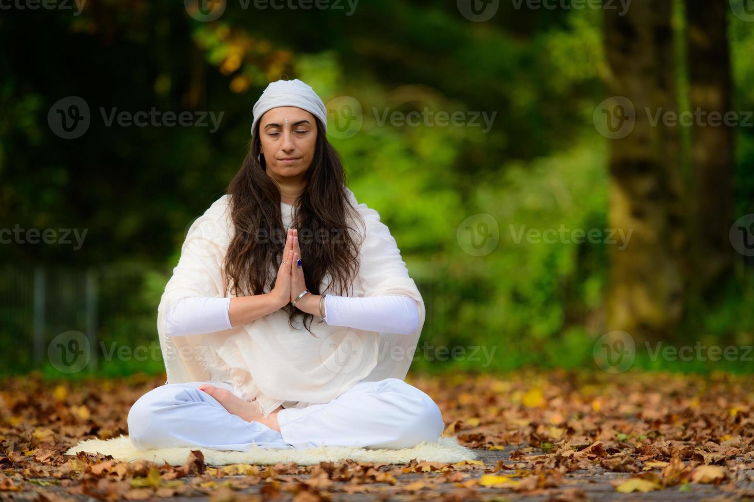 prática de ioga no parque de outono por uma garota foto