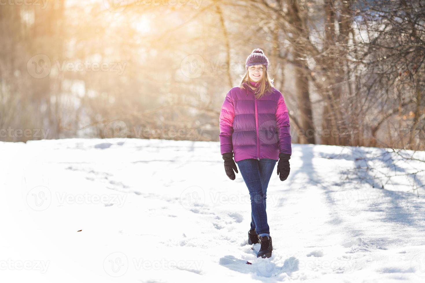 garota alegre andando na neve foto