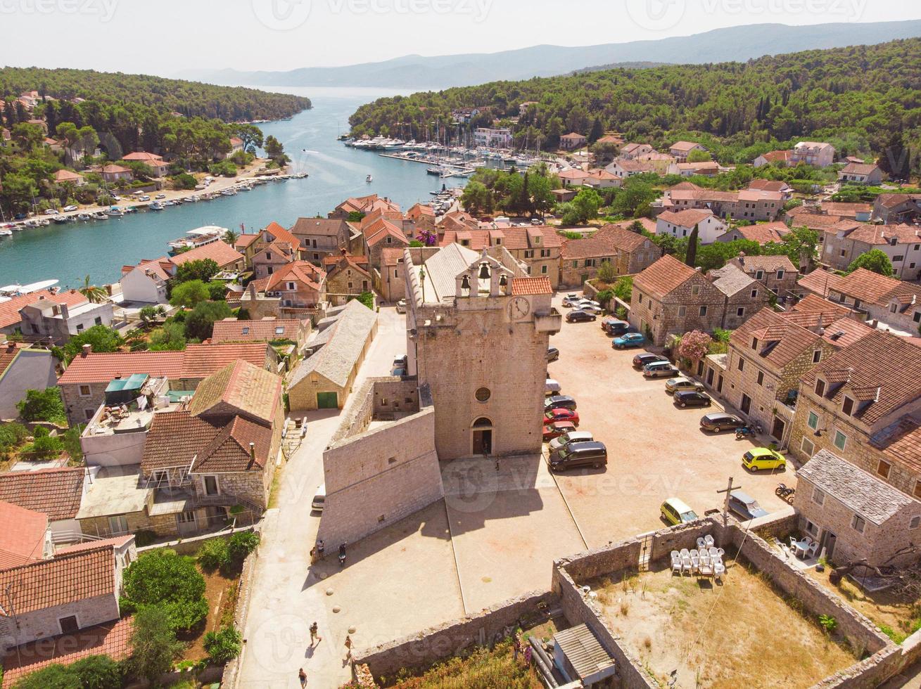 baía e cidade velha com igreja em vrboska, na ilha de hvar, croácia foto