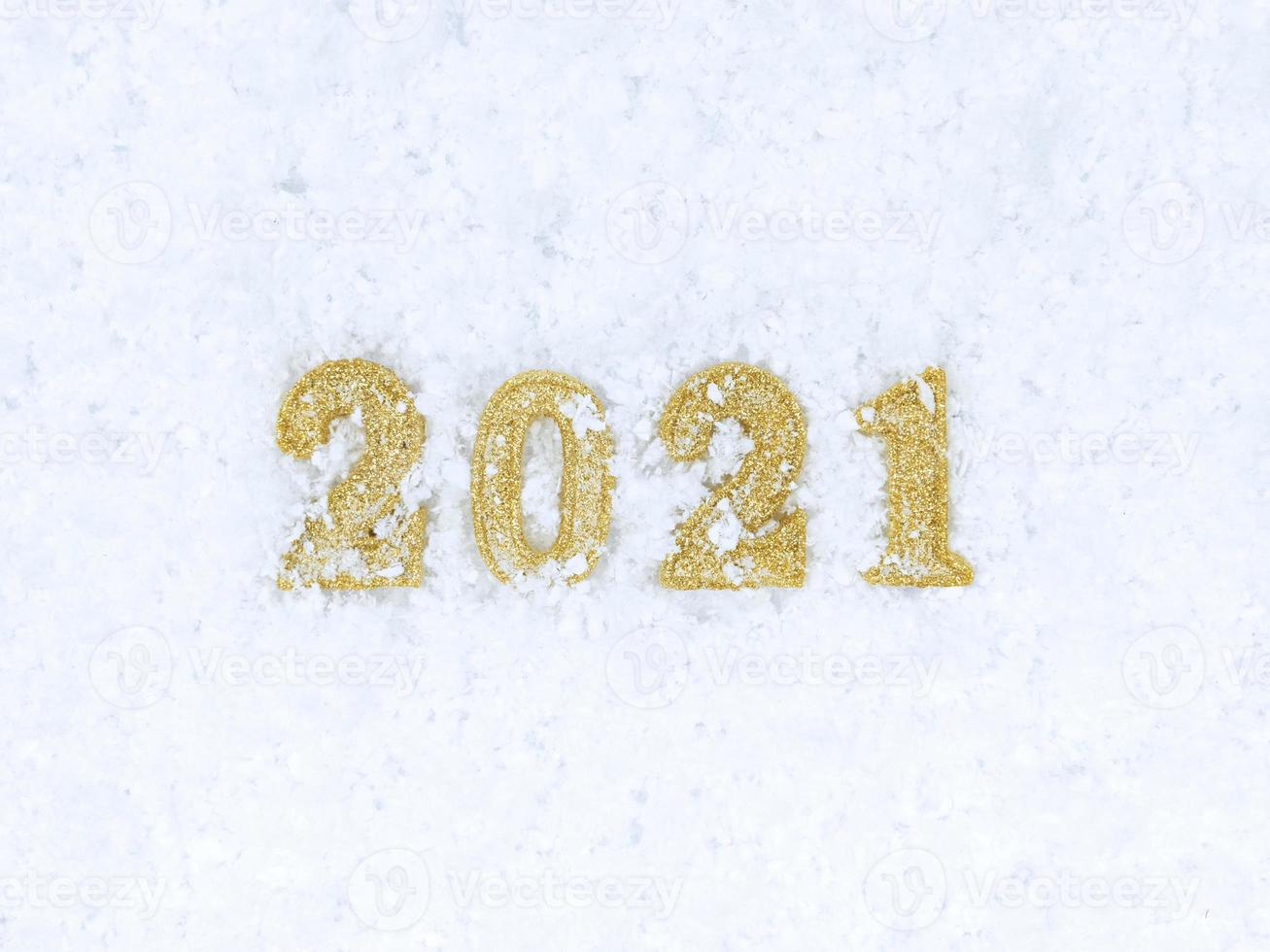 figuras do ano novo 2021 no fundo branco da textura da neve. foto