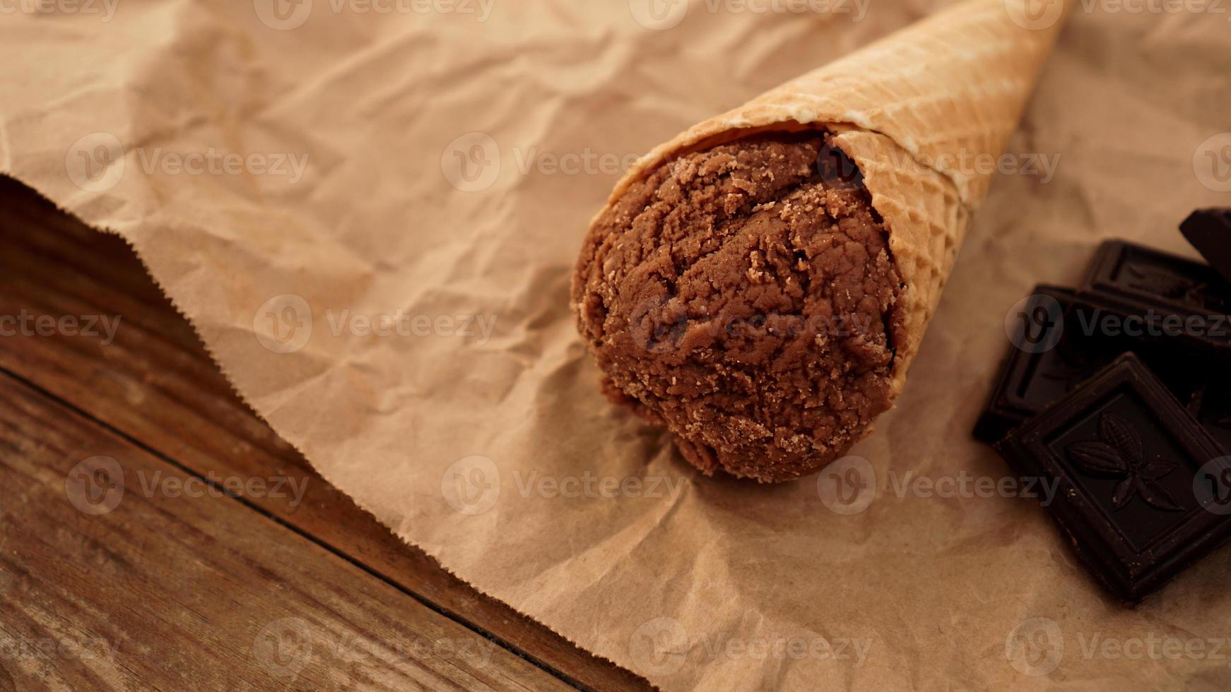 sorvete de chocolate em casquinha de waffle em papel artesanal foto