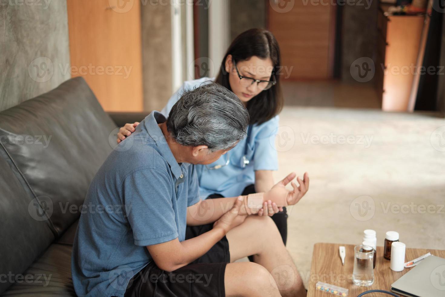 terapeuta médica examina paciente idoso em casa. foto