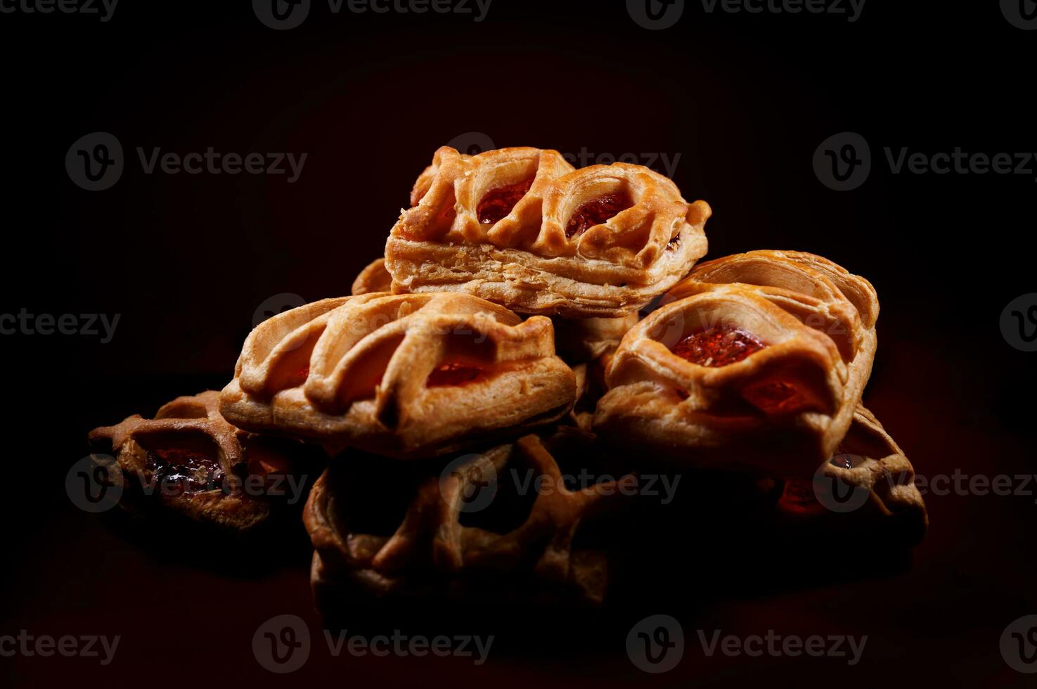 sopro pastelaria pastelaria com amora silvestre geléia em uma Sombrio vermelho fundo. biscoitos com amora silvestre geléia. foto