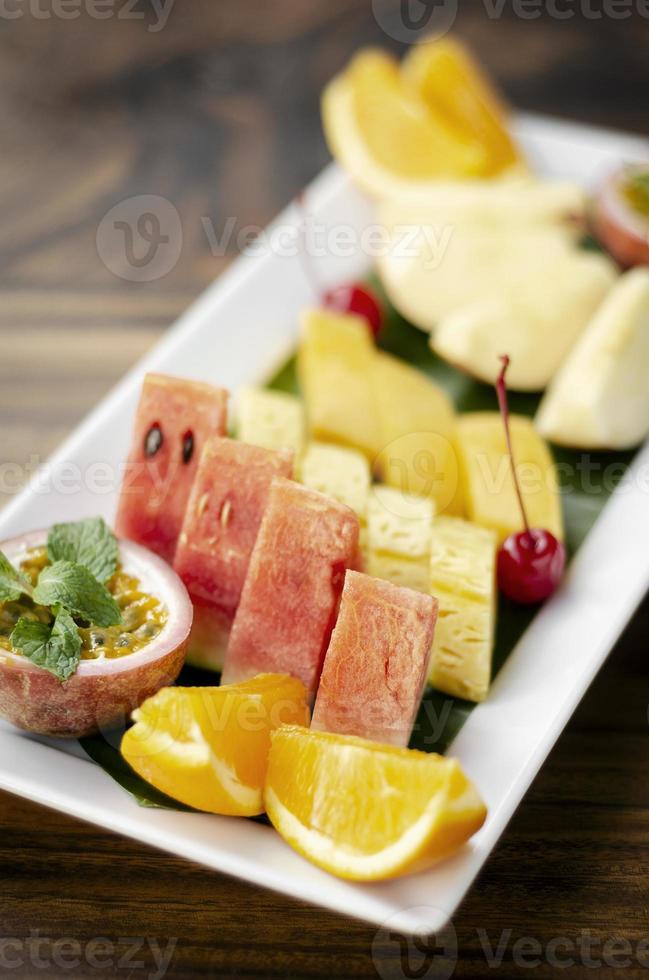 prato misto de salada de frutas orgânicas de corte fresco ao ar livre na mesa de madeira foto