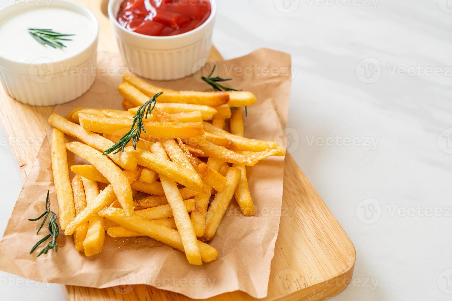 batatas fritas com creme de leite e ketchup foto