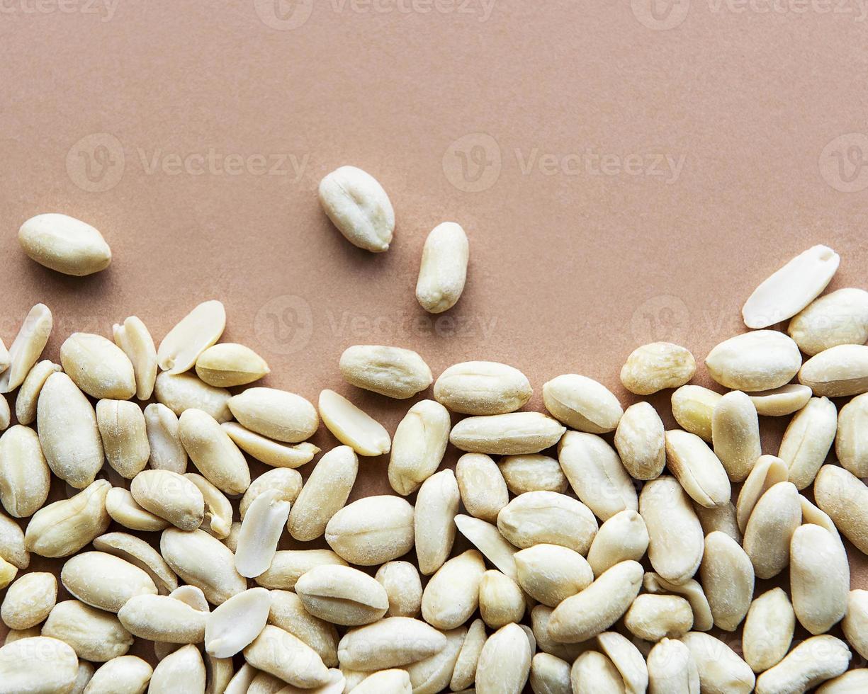 amendoim descascado em um fundo marrom foto