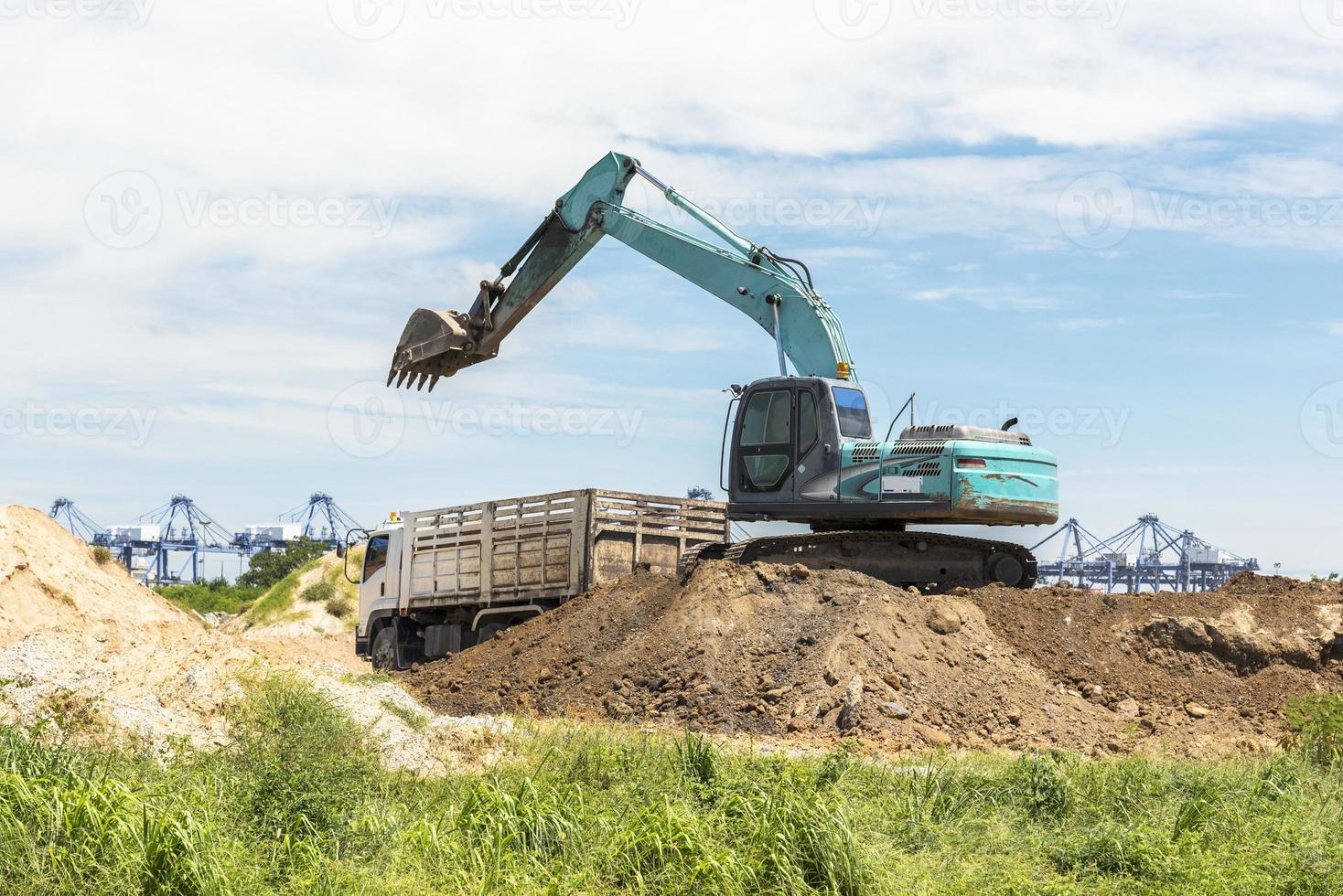 carga do carro da escavadeira e transferência do solo para o caminhão foto