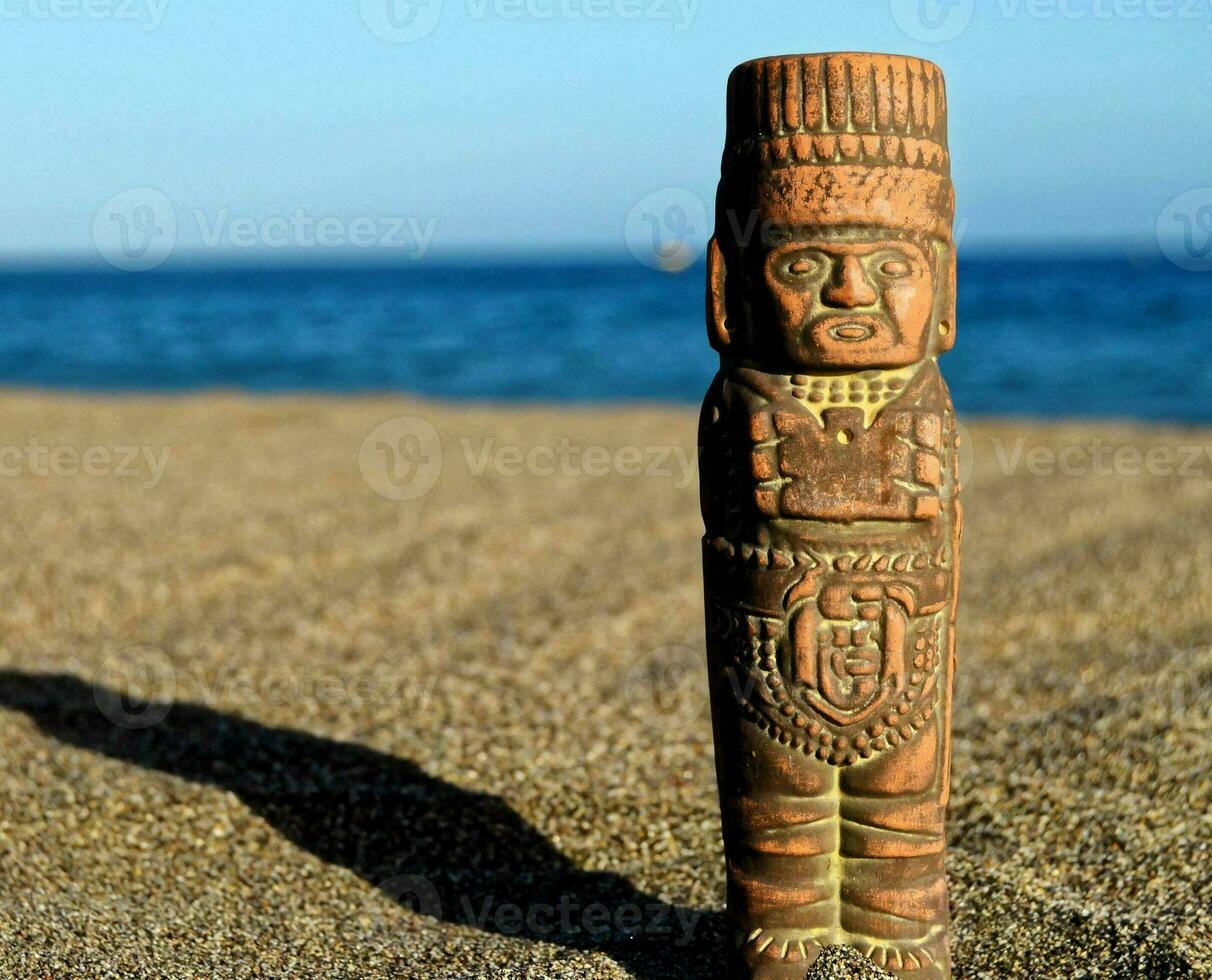 pequena estátua na areia foto