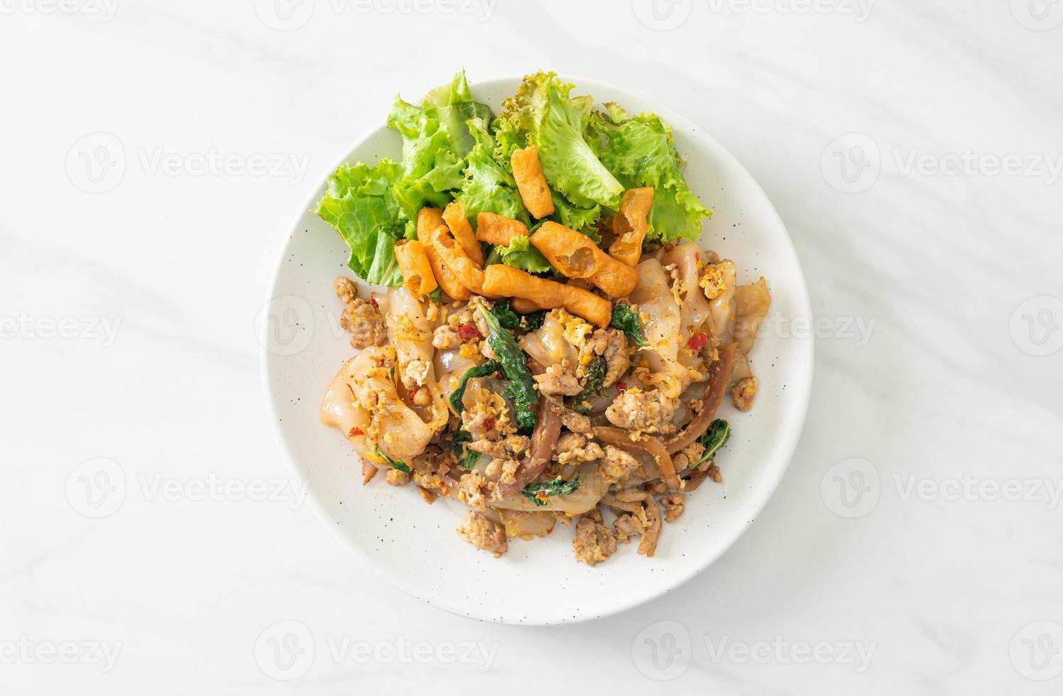 macarrão frito com frango picado e manjericão foto