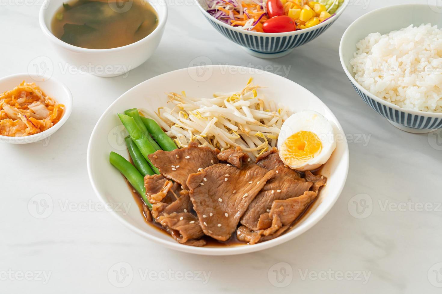 porco teriyaki com sementes de gergelim, brotos de feijão mungo, ovo cozido foto