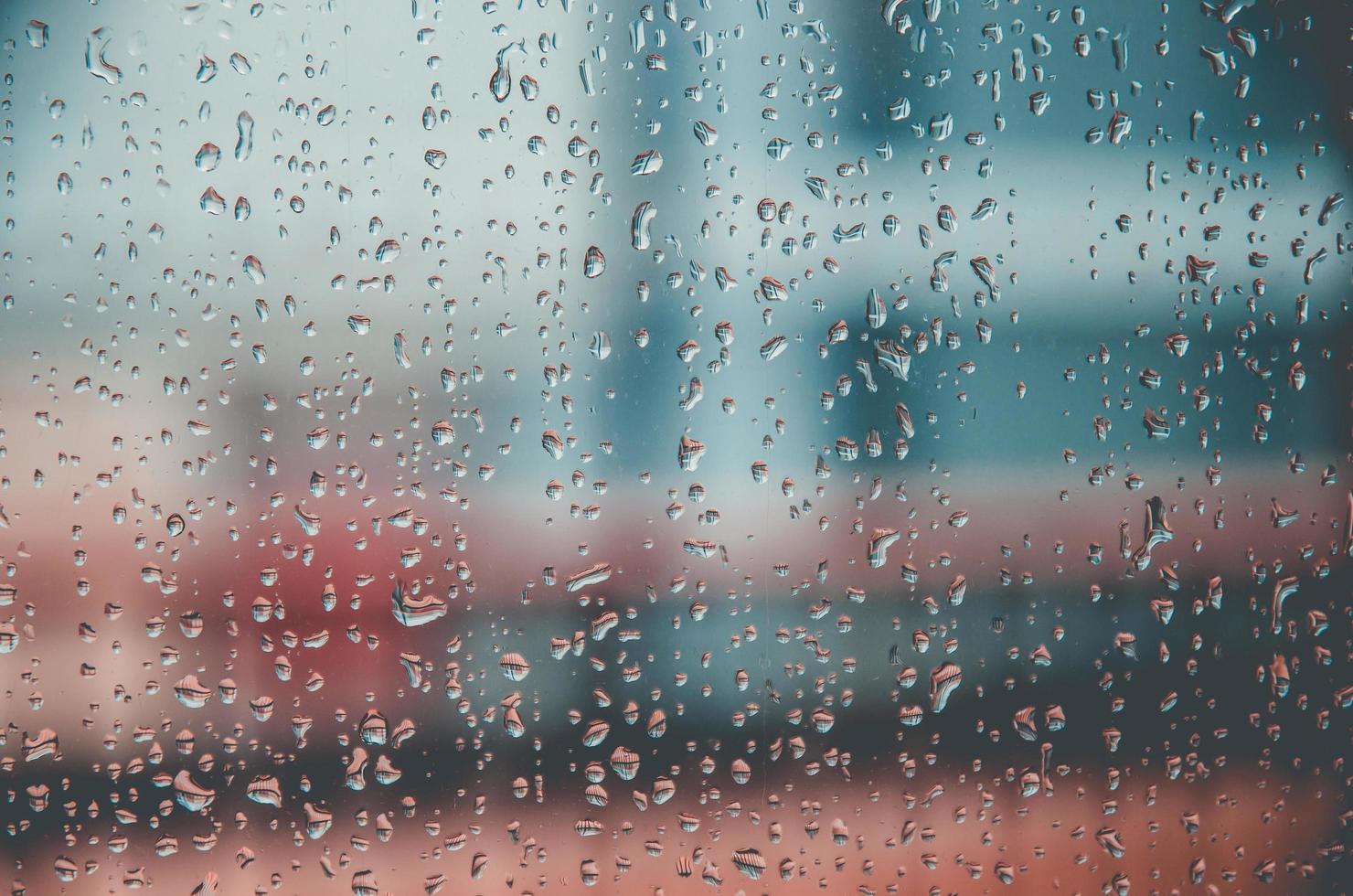 fundo e papel de parede por gota chuvosa e gotas de água na janela. foto