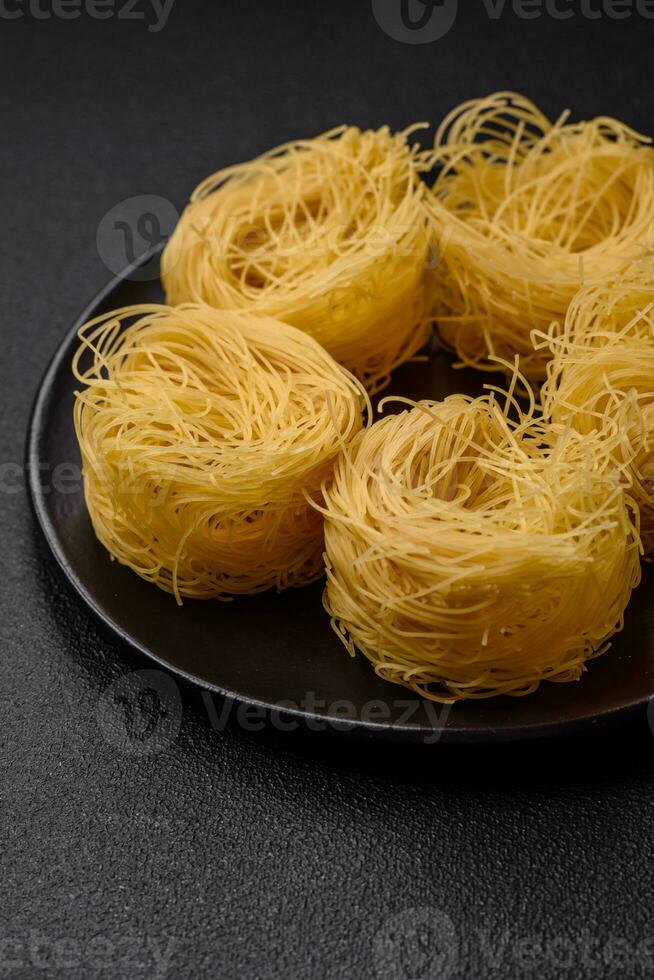 cru capellini massa ou Macarrão com sal e especiarias foto