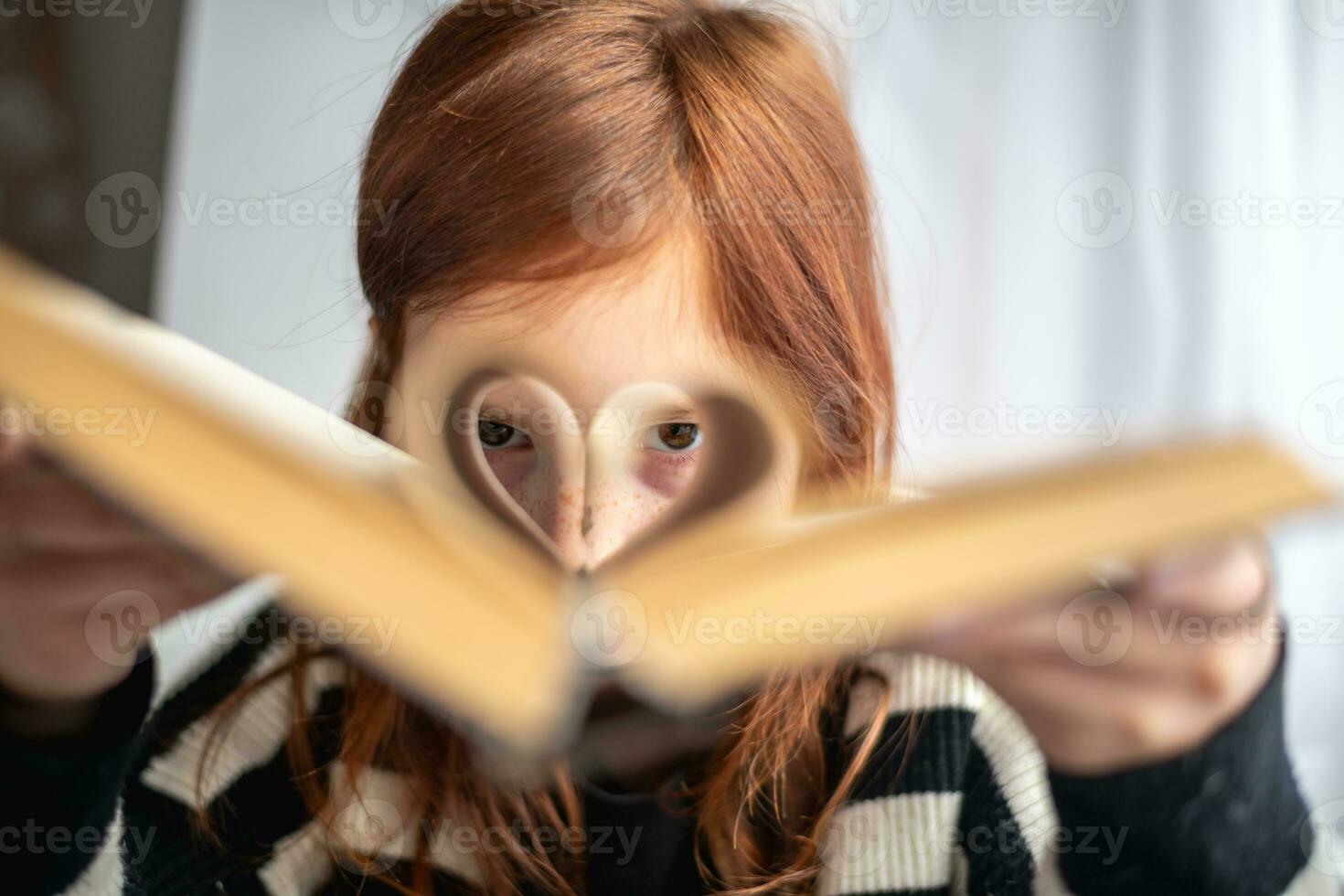 uma menina é segurando uma livro. em forma de coração Páginas. leitura, sabendo, Aprendendo foto