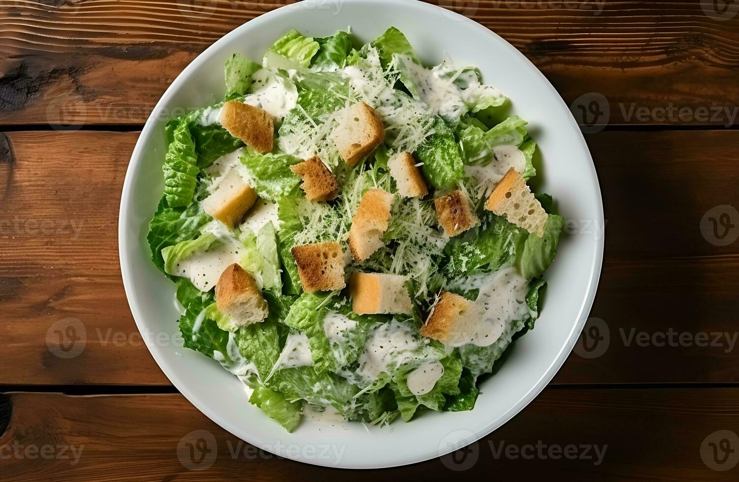 César salada com grelhado frango carne, alface e queijo, tiro a partir de a topo em a de madeira mesa fundo foto