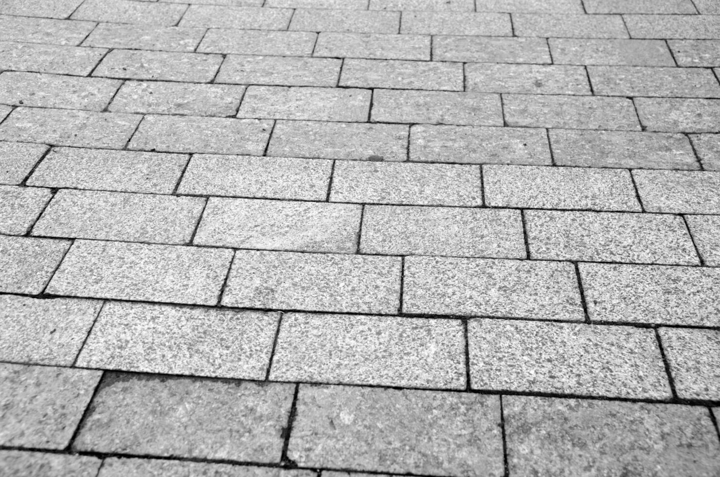 tijolos e pedras cidade calçada padrão, estrada textura Preto e branco fundo foto