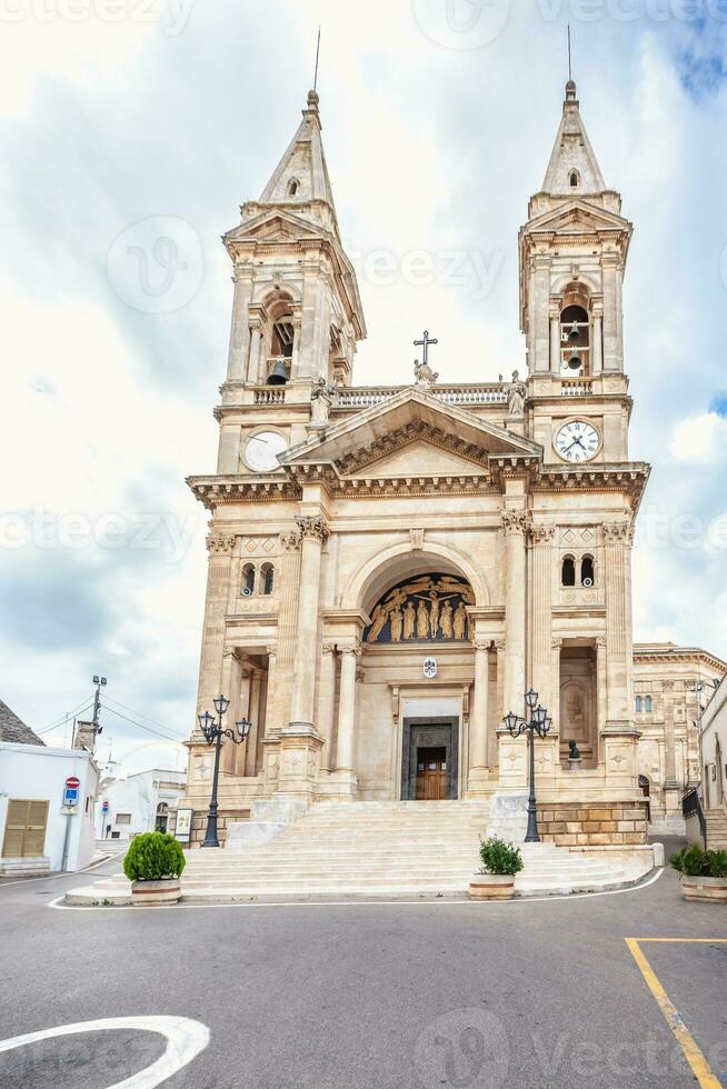 alberobello, puglia, Itália. Visão do a famoso Vila com catedral do santos cosmos e Damião. foto