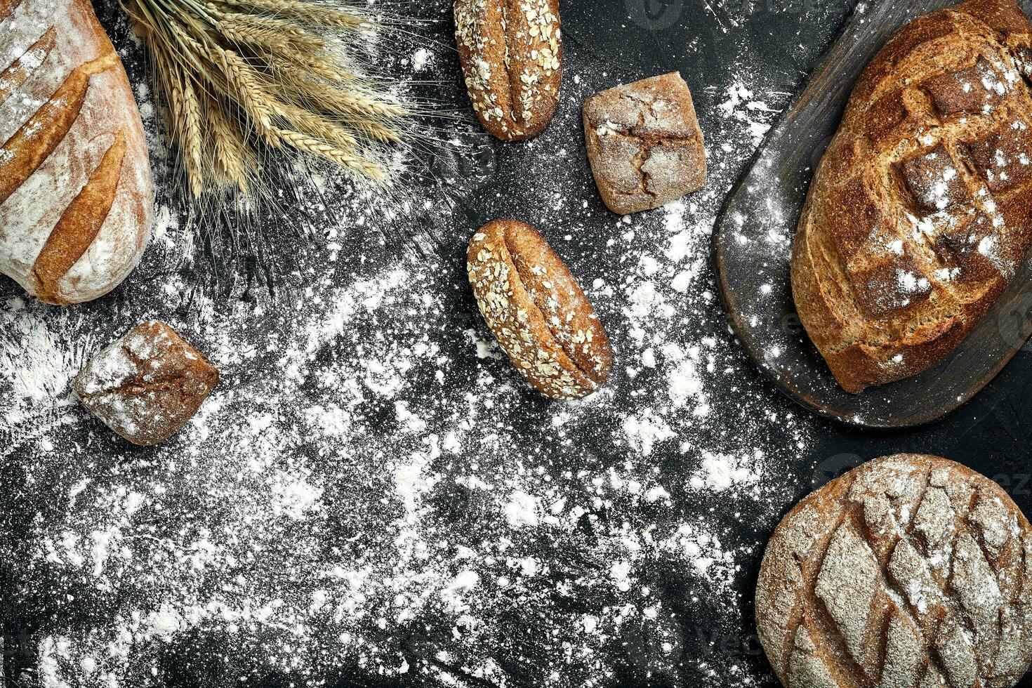 diferente pão com farinha e espiguetas do Wheaton Preto fundo foto