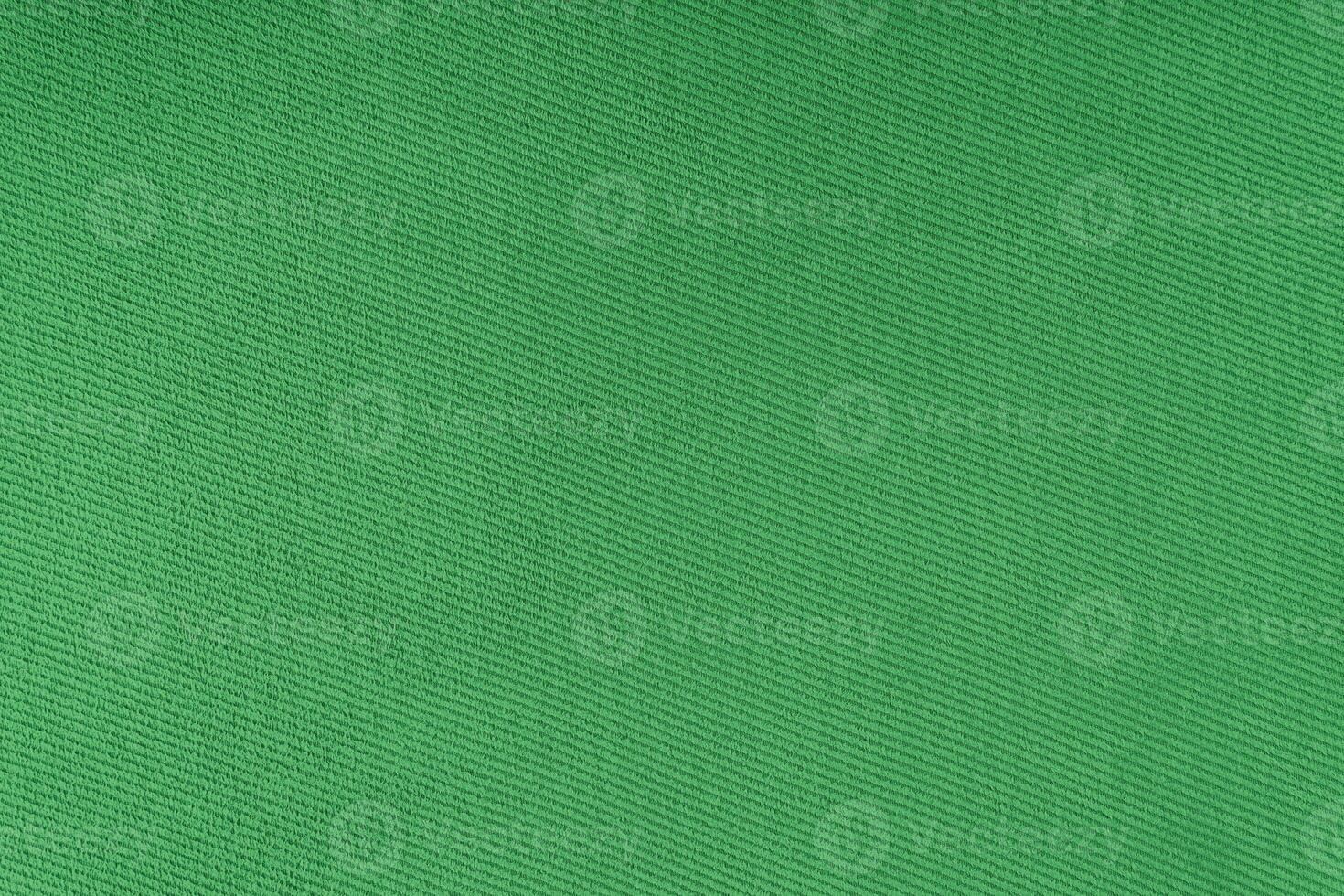 textura do padrão de tecelagem diagonal de tecido verde. fundo têxtil decorativo foto
