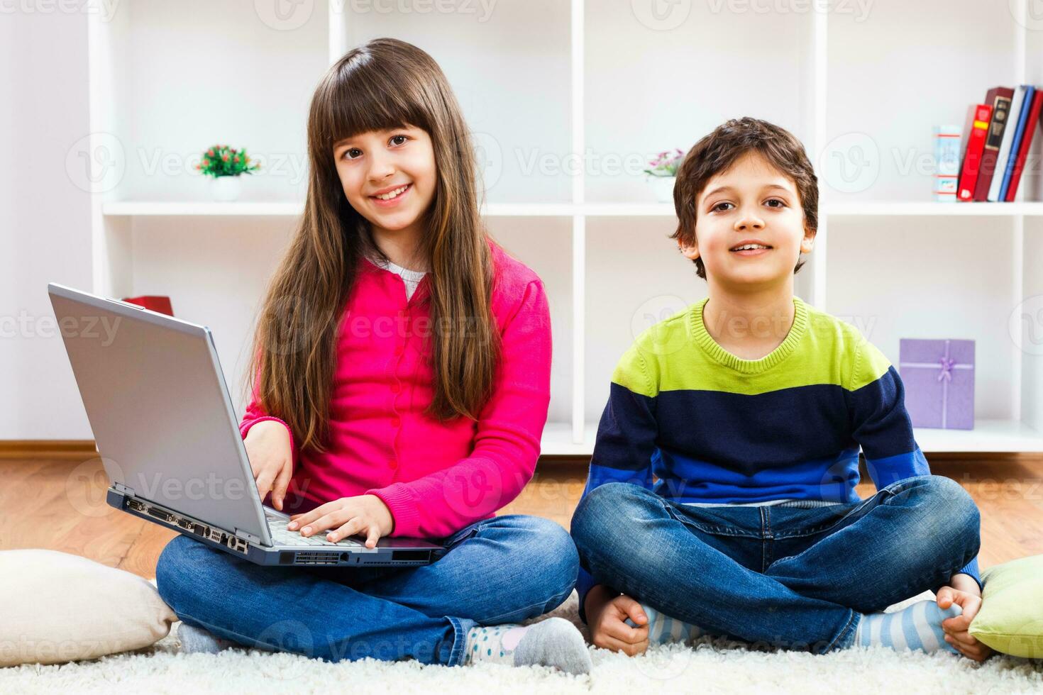 dois crianças usando computador portátil foto