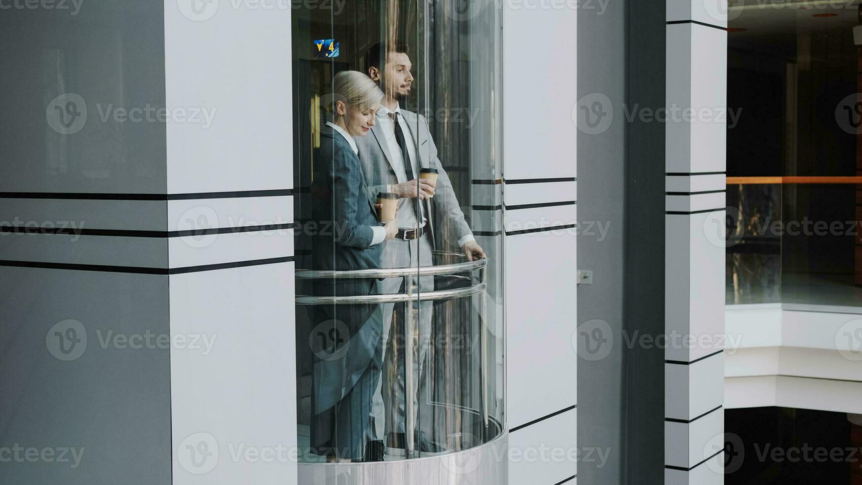 empresária e homem de negocios colegas falando dentro comovente elevador dentro moderno o negócio Centro dentro de casa foto