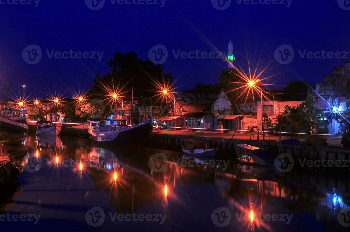 rio acima do a rio às pasuruan Porto dentro Indonésia, muitos pescaria barcos doca às noite foto