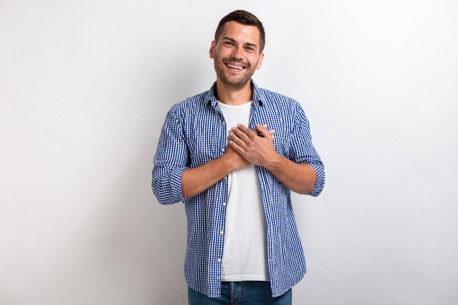 homem mostrando um gesto de amor toca seus braços no peito em estúdio. - imagem foto