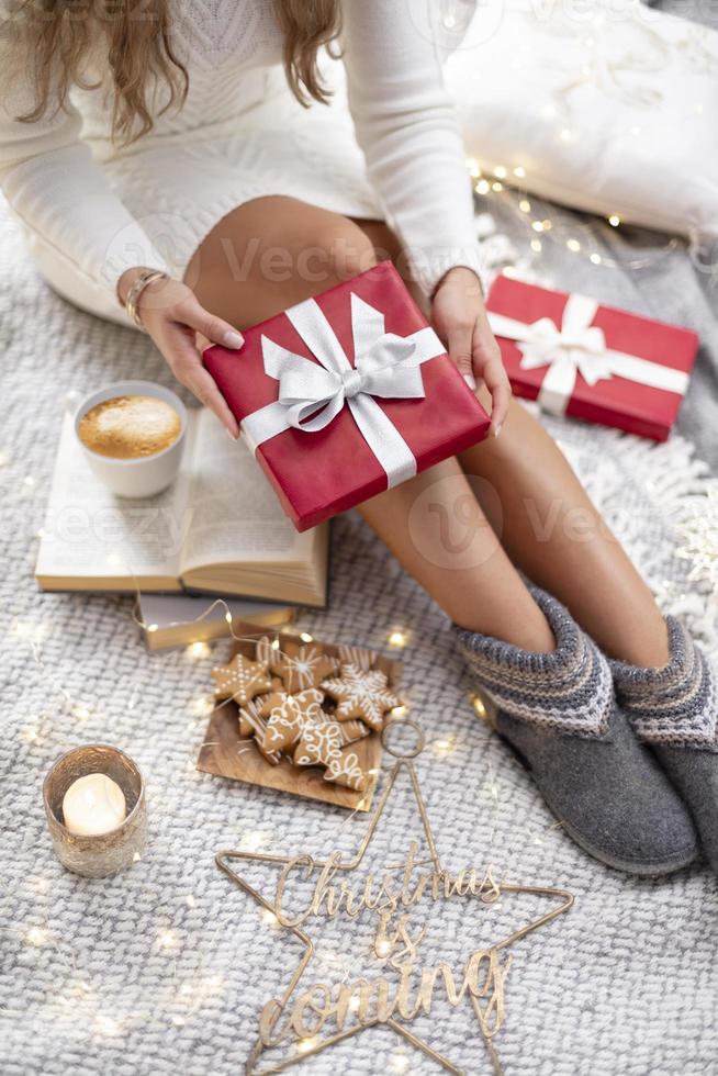 pernas de mulher aconchegantes com meias de Natal e presentes. foto