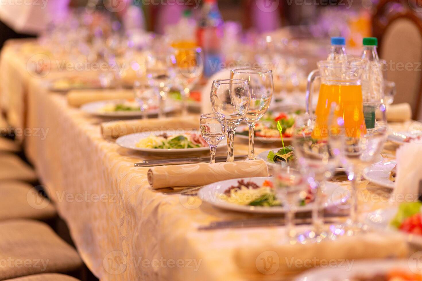 servido festivo mesa com lanches, copos, copos, talheres e guardanapos para uma banquete foto