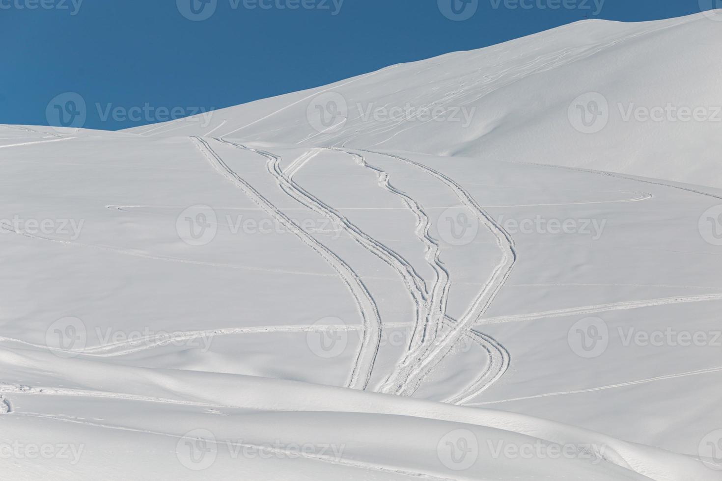 montanhas com estradas de esqui na neve e árvores foto