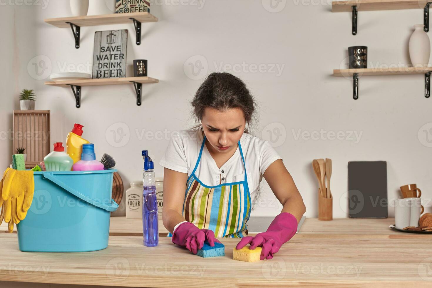 lindo alegre morena mulher dentro luvas limpeza moderno cozinha foto