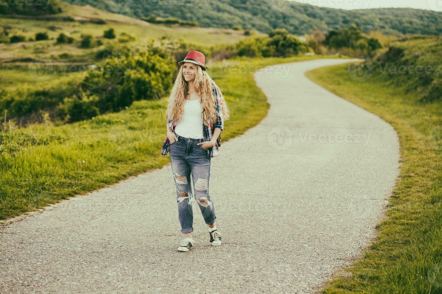 lindo jovem mulher goza caminhando às a país estrada.toned imagem. foto