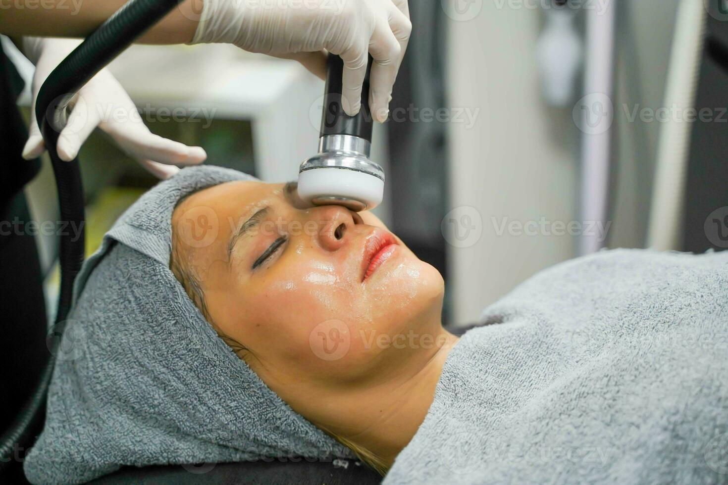 fechar-se ásia beleza mulher tendo terapia para estimular facial pele e facial ultrassônico cuidados com a pele tratamento de profissional cosmetologista bem-estar. foto