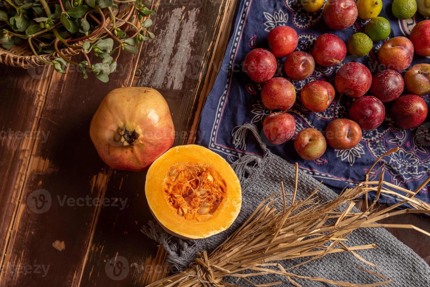 abóboras e muitas outras cores e variedades de frutas e vegetais estão na mesa de grãos de madeira foto