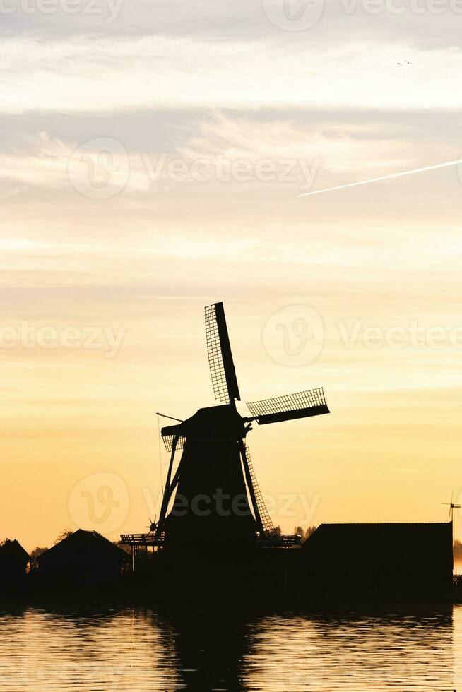 popular turista local Zaanse Schans é perto amsterdam dentro a oeste do a Holanda. histórico, realista moinhos de vento durante nascer do sol. Holanda ponto de referência foto