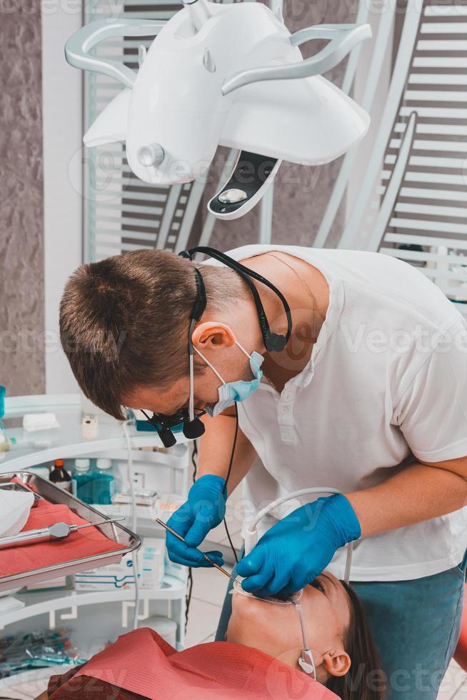 o dentista usa um raspador para remover o tártaro, higiene bucal. foto