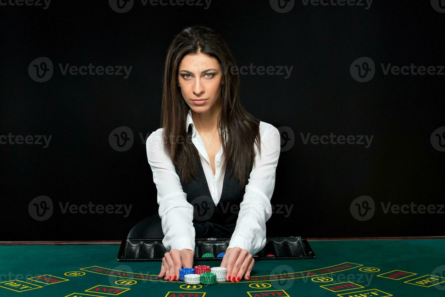 a lindo garota, distribuidor, atrás uma mesa para pôquer foto