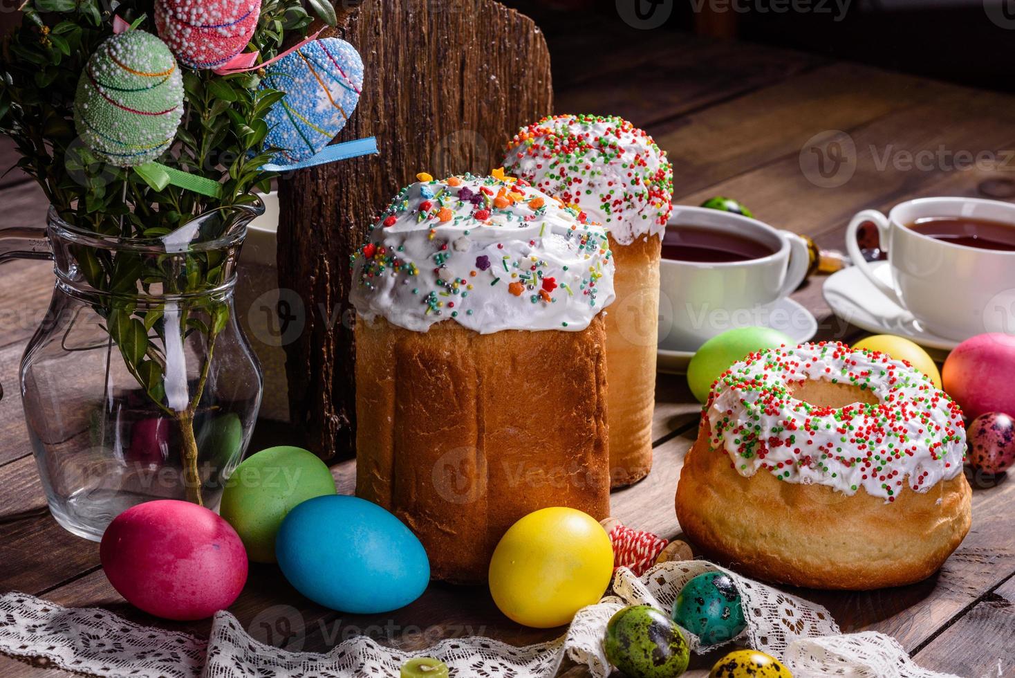 bolo de páscoa e ovos coloridos em um fundo escuro foto
