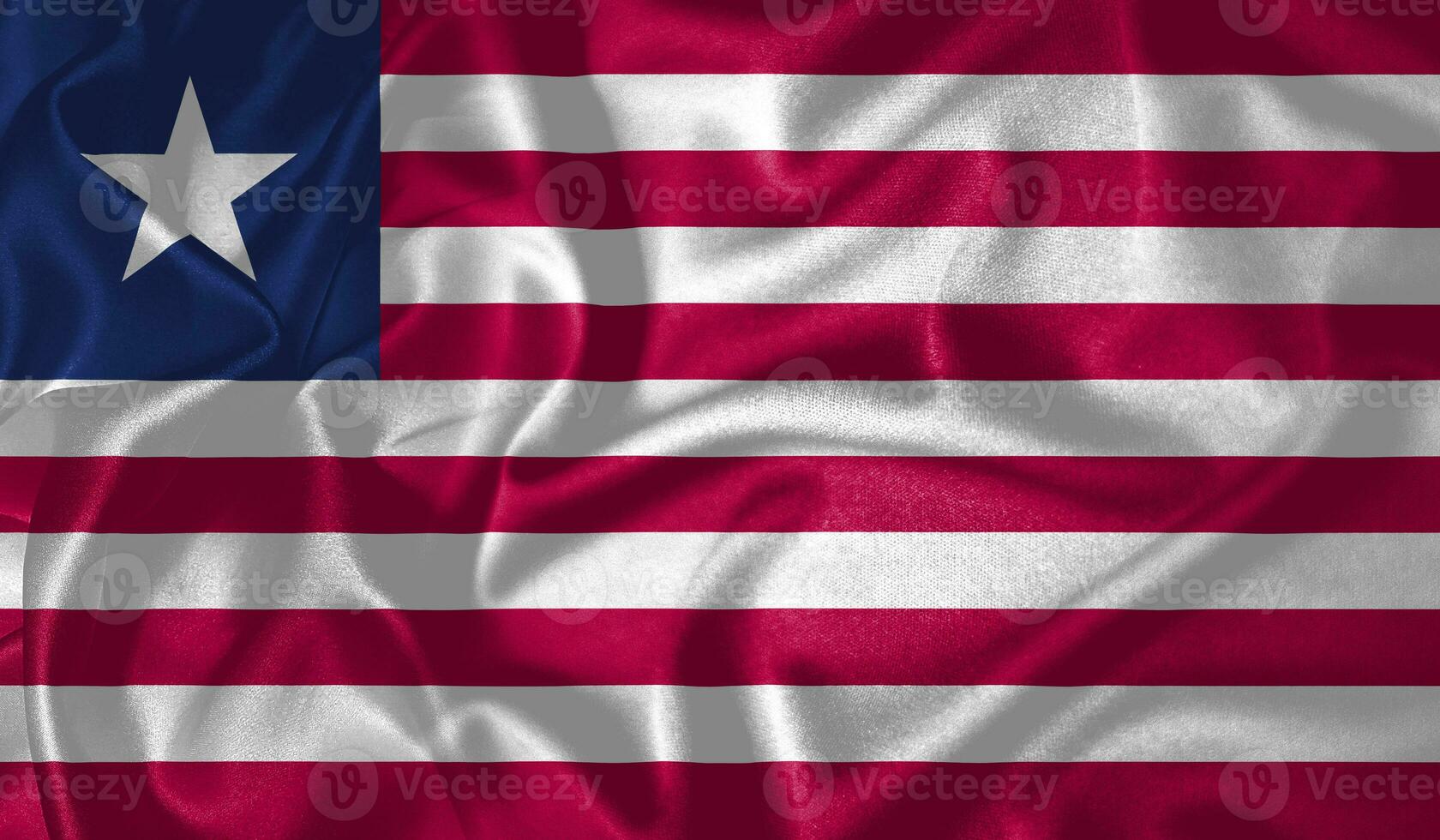 Libéria bandeira acenando tremulando dentro a vento com realista textura tecido seda cetim fundo foto